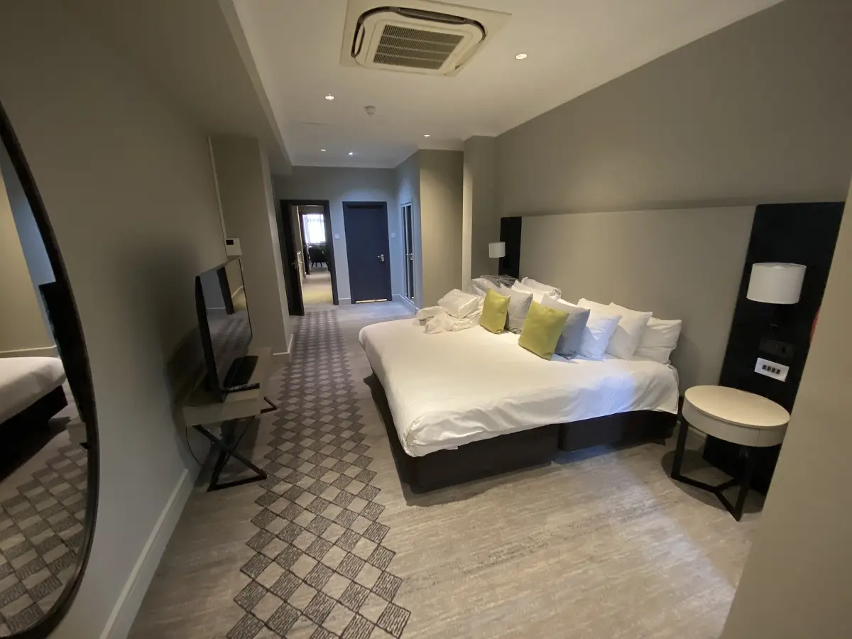 Image of hotel bedroom suite at DoubleTree by Hilton Kensington London